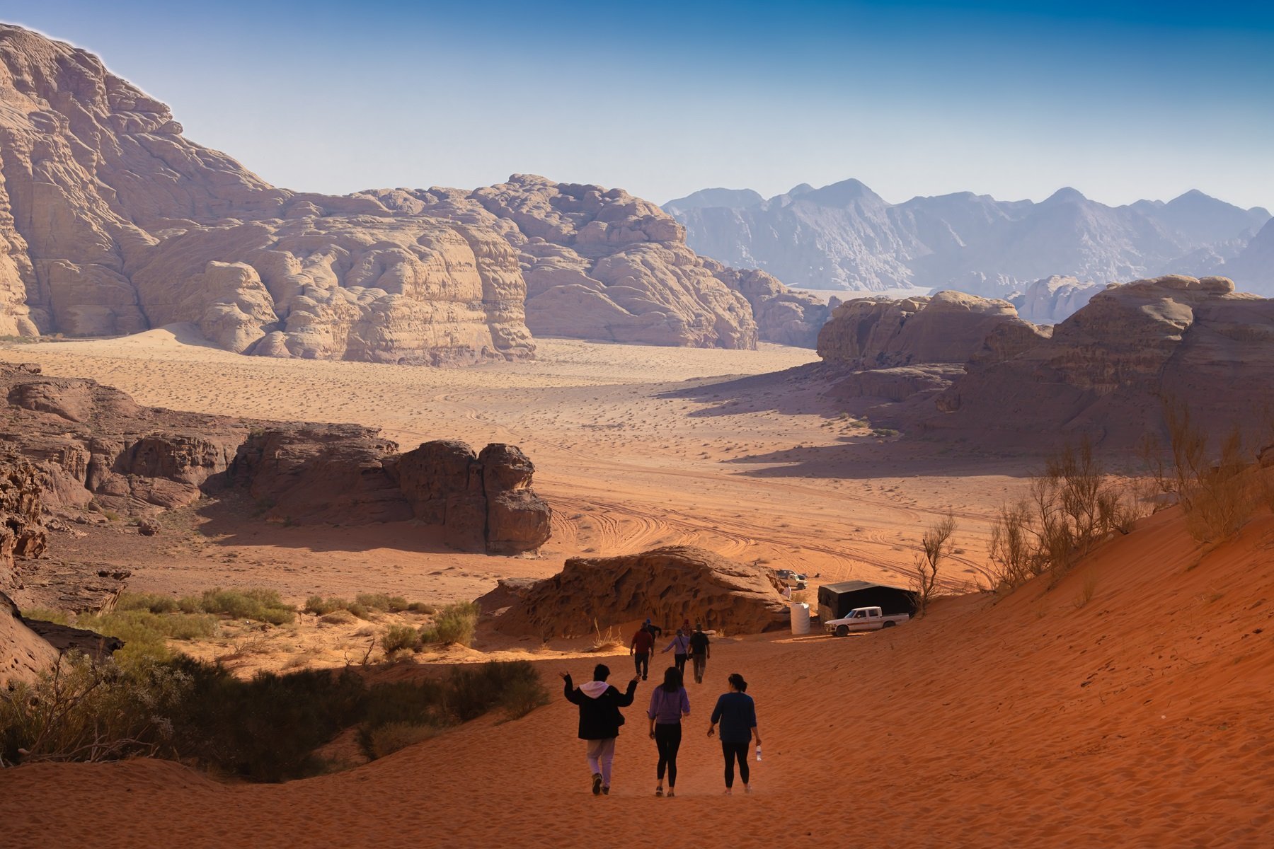 Tourists Wandering Through Wadi Rum Desert
